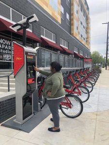 A woman using Capital BikeShare bicycle rental